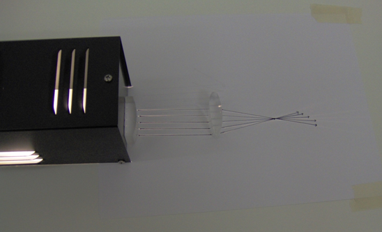 There are three objects in this figure. A plano-convex lens is placed in front of the light source to produce some parallel light rays. These parallel rays are incident on a convex lens such that the light rays after passing through the convex lens converge at a point.